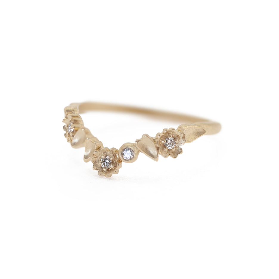 Handmade floral engagement ring V guard band with buttercup flower details and botanical elements and bezel set diamonds in 18K yellow gold by Designer Megan Thorne