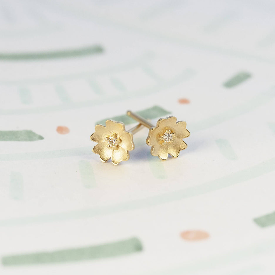 Handmade floral stud earrings with flower Buttercup holding diamonds in 18K yellow gold by Designer Megan Thorne