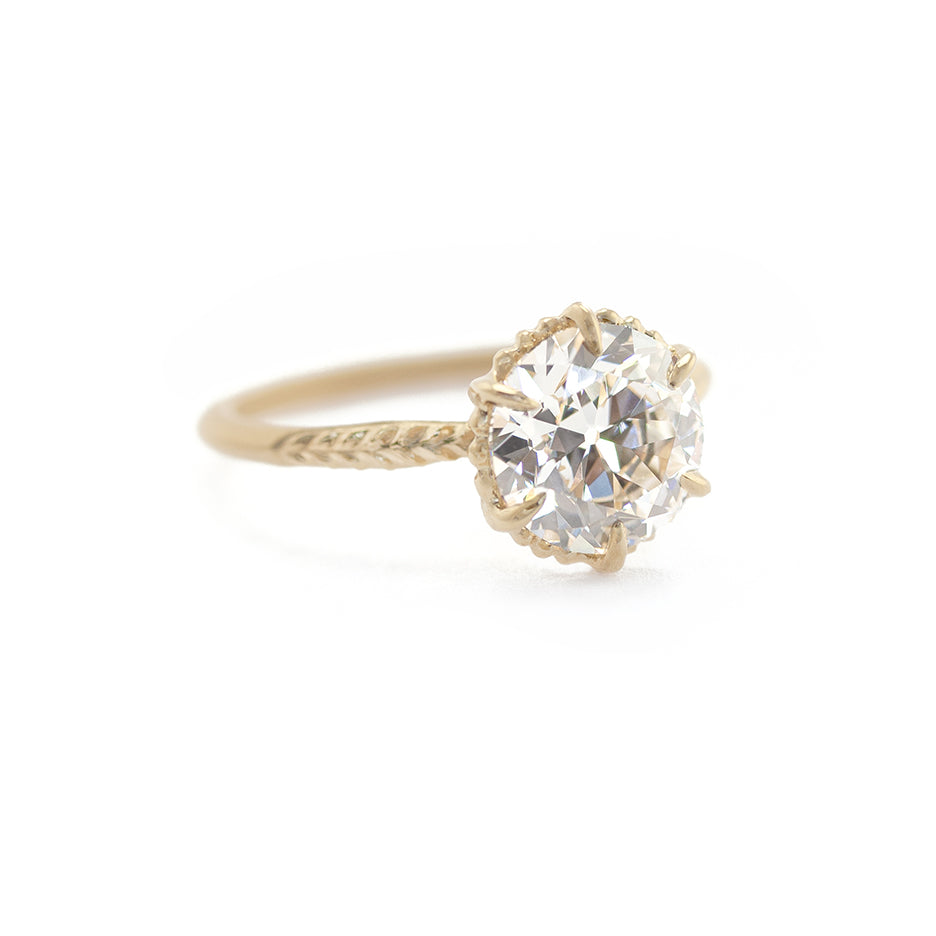Handmade solitaire engagement ring with 2.2ct Lab Grown old European Cut diamond and botanical Evergreen details in 18K yellow gold by Designer Megan Thorne