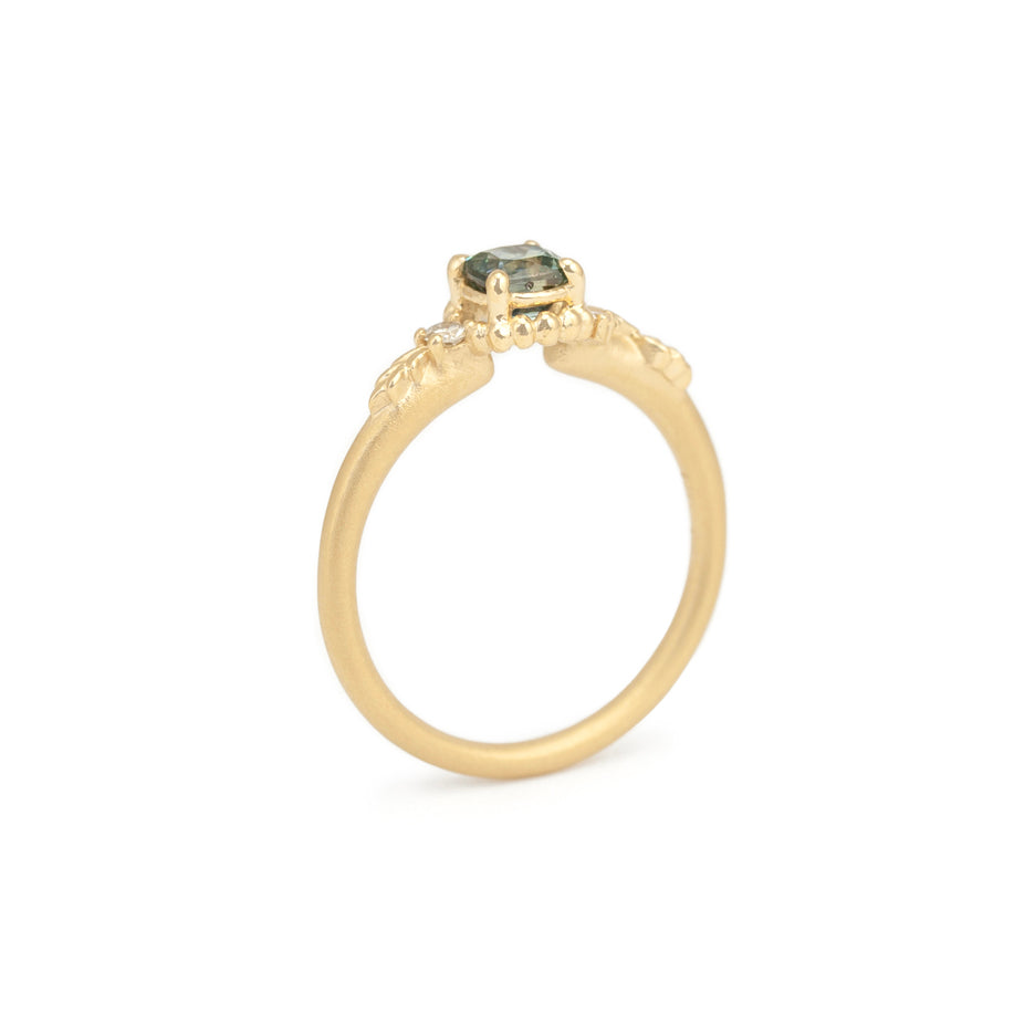 Green Sapphire Engagement Ring in Yellow Gold with Botanical Detailing Through Finger View