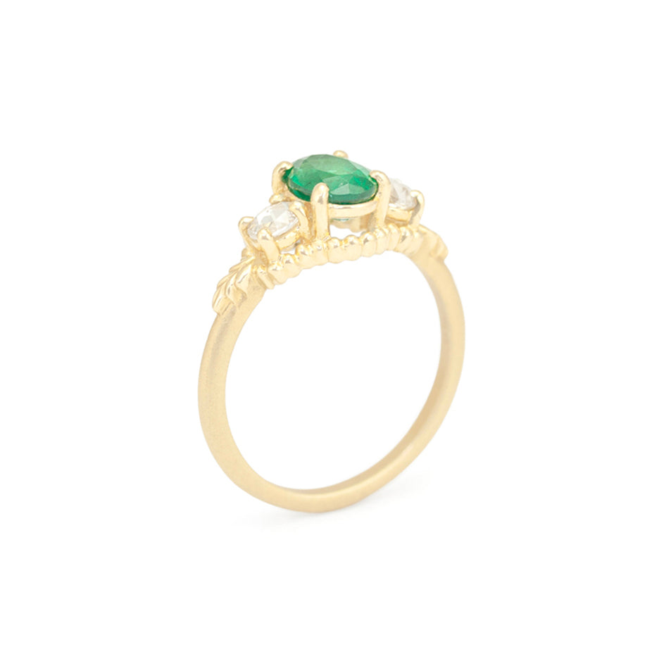 Emerald 3 Stone Engagement Ring in Yellow Gold with Botanical Detailing Through Finger View