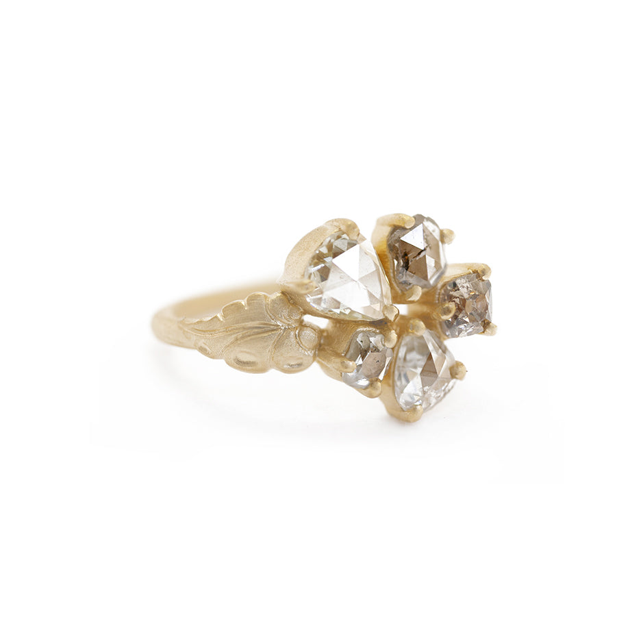 Handmade nontraditional engagement ring featuring 5 rustic antique diamonds and floral leaf details in 18K yellow gold by Designer Megan Thorne