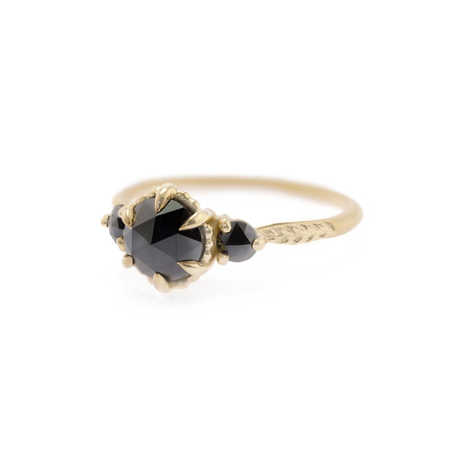 Handmade alternative engagement or statement ring with black rose cut diamonds and botanical Evergreen details in 18K yellow gold by Designer Megan Thorne