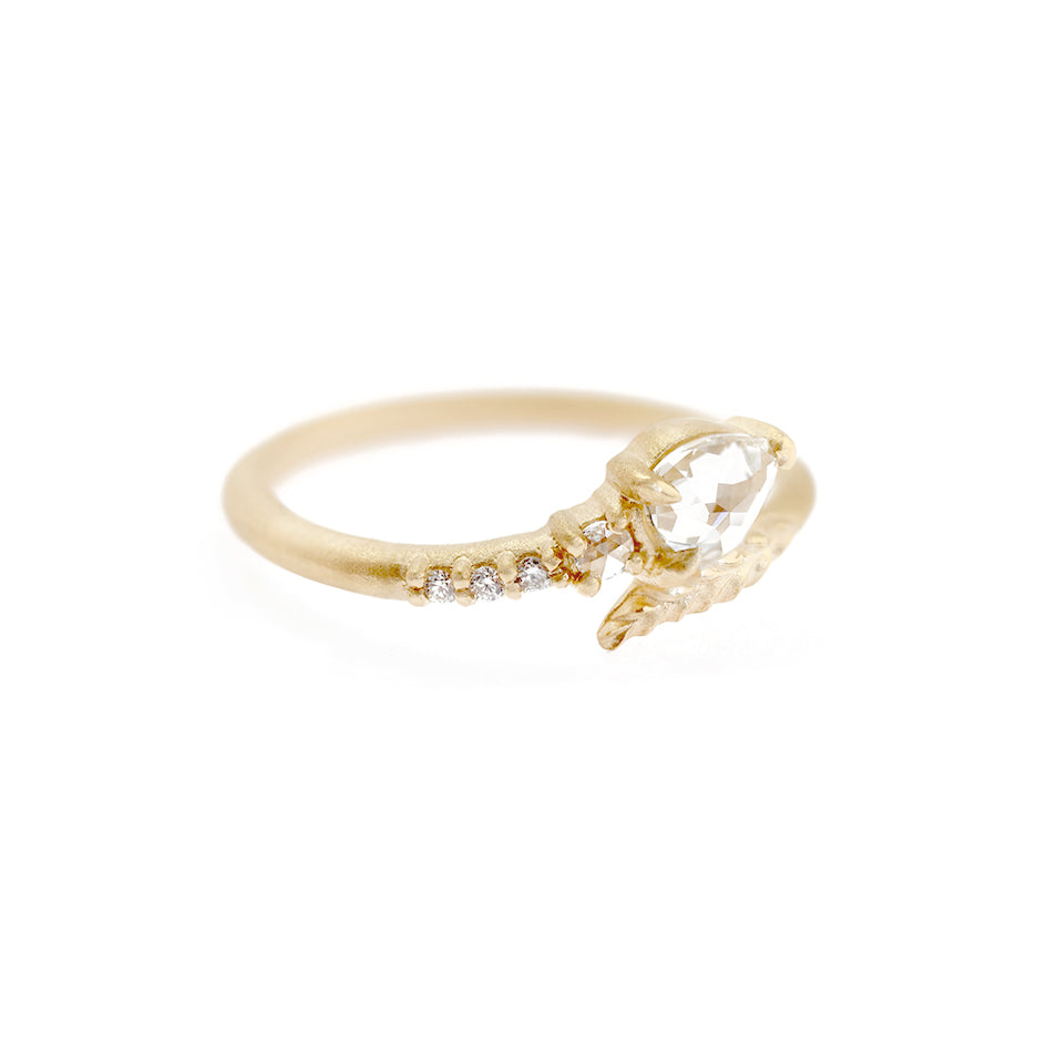 Handmade vintage inspired engagement ring with unexpected Evergreen leaf encircling a pear rose cut diamond and diamond accents in 18K yellow gold by Designer Megan Thorne