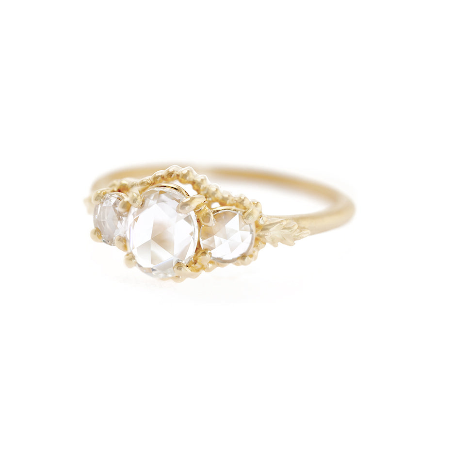 Handmade classic 3-stone engagement ring featuring rose cut oval diamonds and floral beading and Wood Nymph details in 18K yellow gold by Designer Megan Thorne
