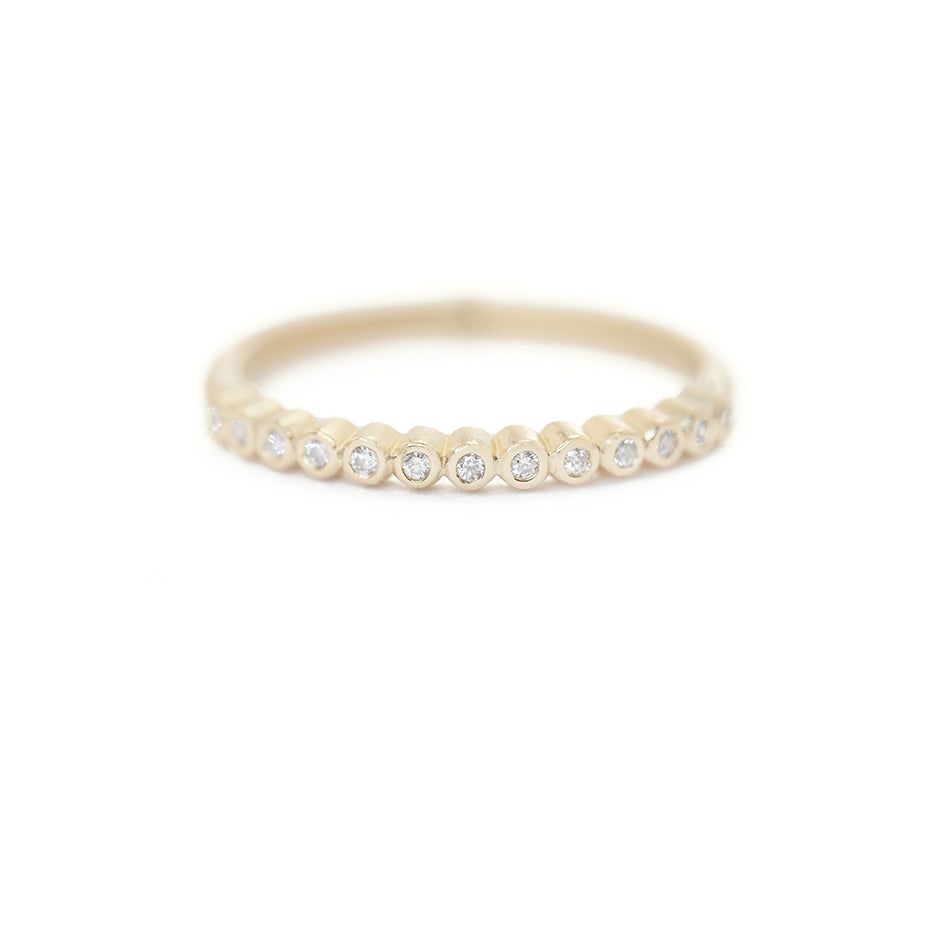 Handmade vintage inspired surprise wedding band with bezel set diamonds in 18K yellow gold by Designer Megan Thorne