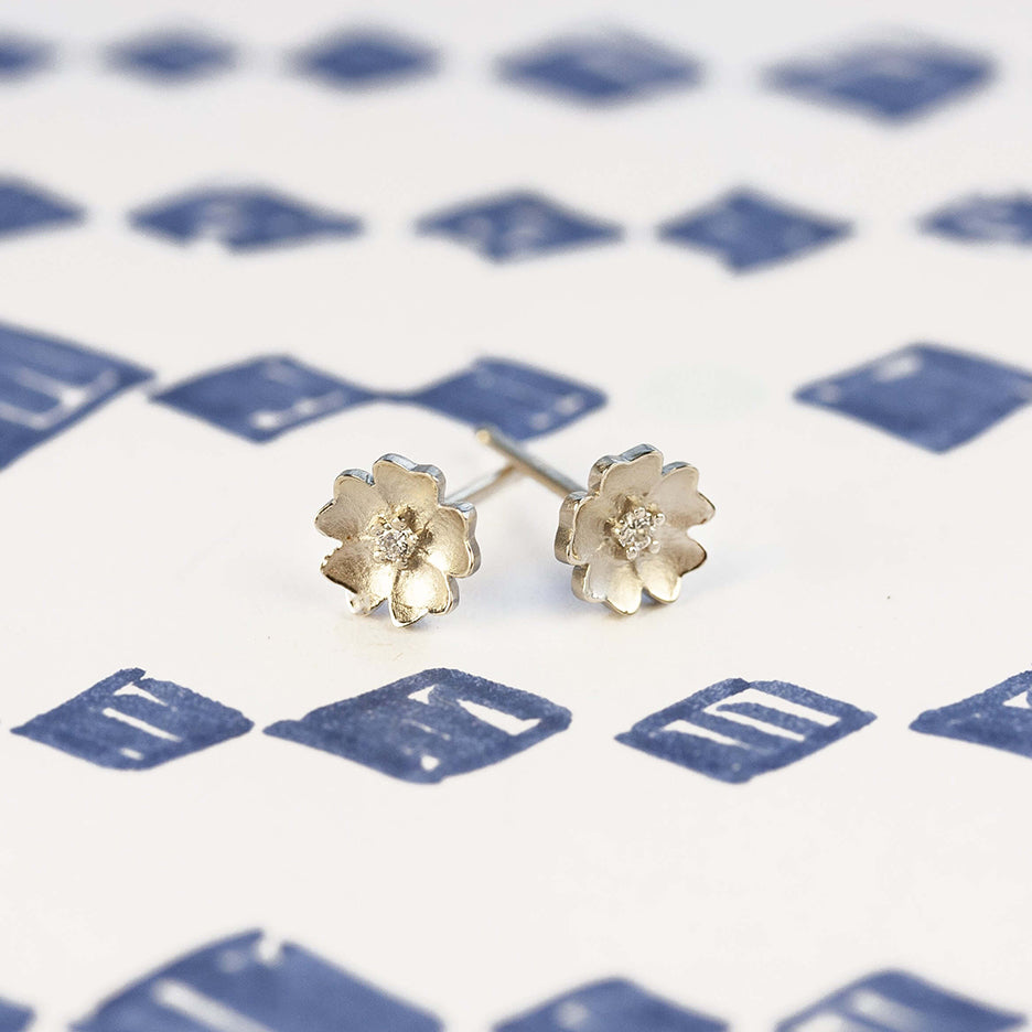 Handmade floral stud earrings with flower Buttercup holding diamonds in 18K white gold by Designer Megan Thorne