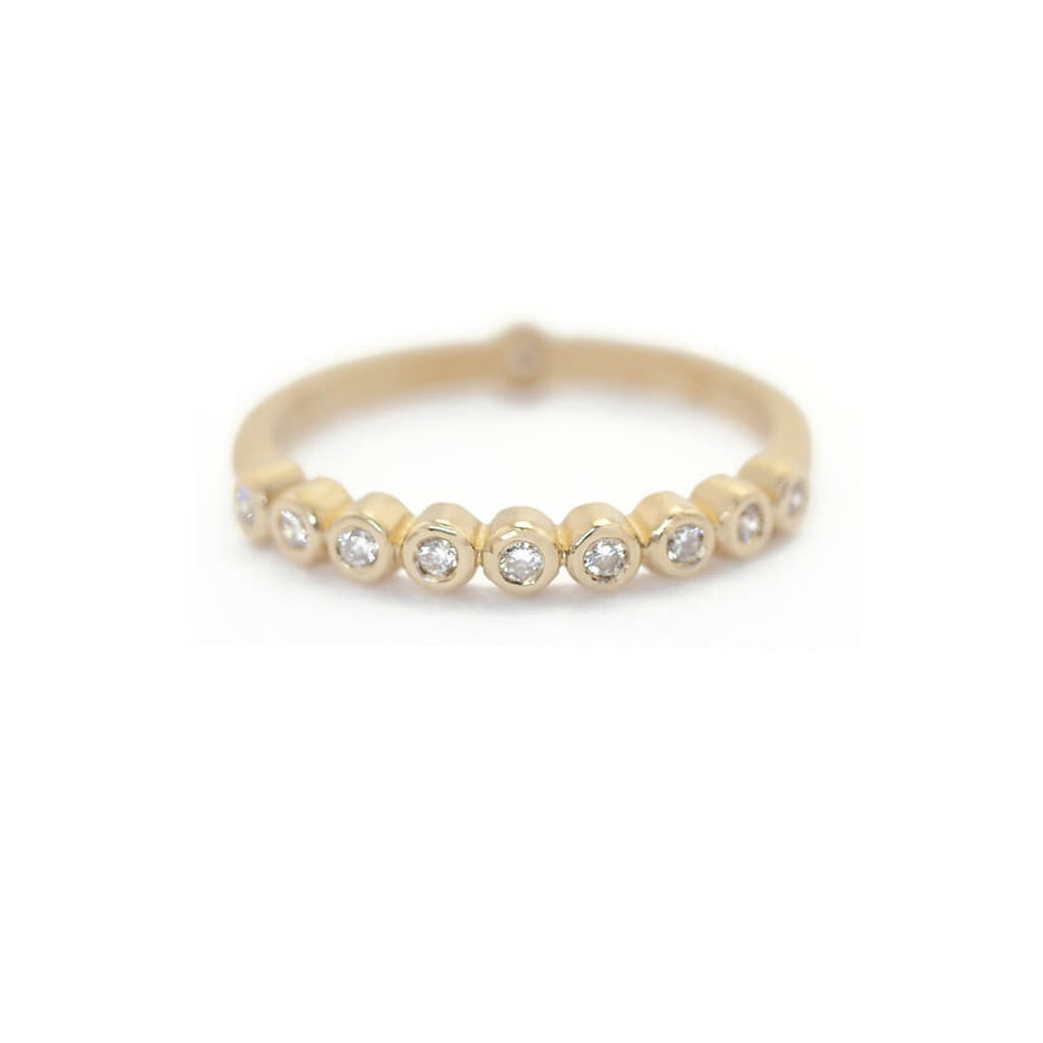 Handmade wedding or stacking band with bezel set diamonds in 18K yellow gold by Designer Megan Thorne