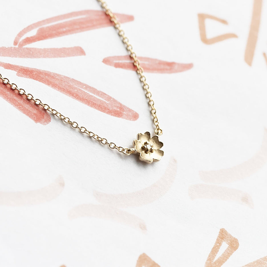 Handmade floral necklace with Buttercup flower with diamond in 18K yellow gold by Designer Megan Thorne