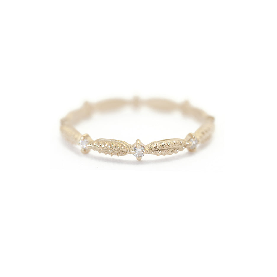 Handmade wedding band featuring botanical elements and white diamonds in 18K yellow gold by Designer Megan Thorne