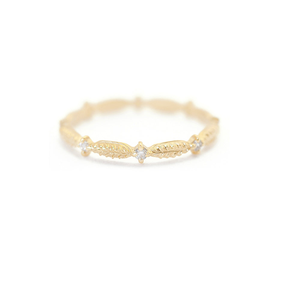 Handmade wedding band featuring botanical elements and white diamonds in 18K yellow gold by Designer Megan Thorne