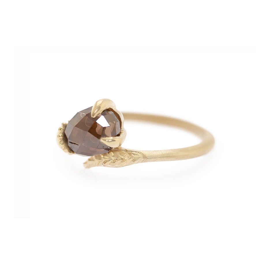 Handmade alternative engagement ring featuring unique richly colored brown briolette diamond and botanical Evergreen details in 18K yellow gold by Designer Megan Thorne