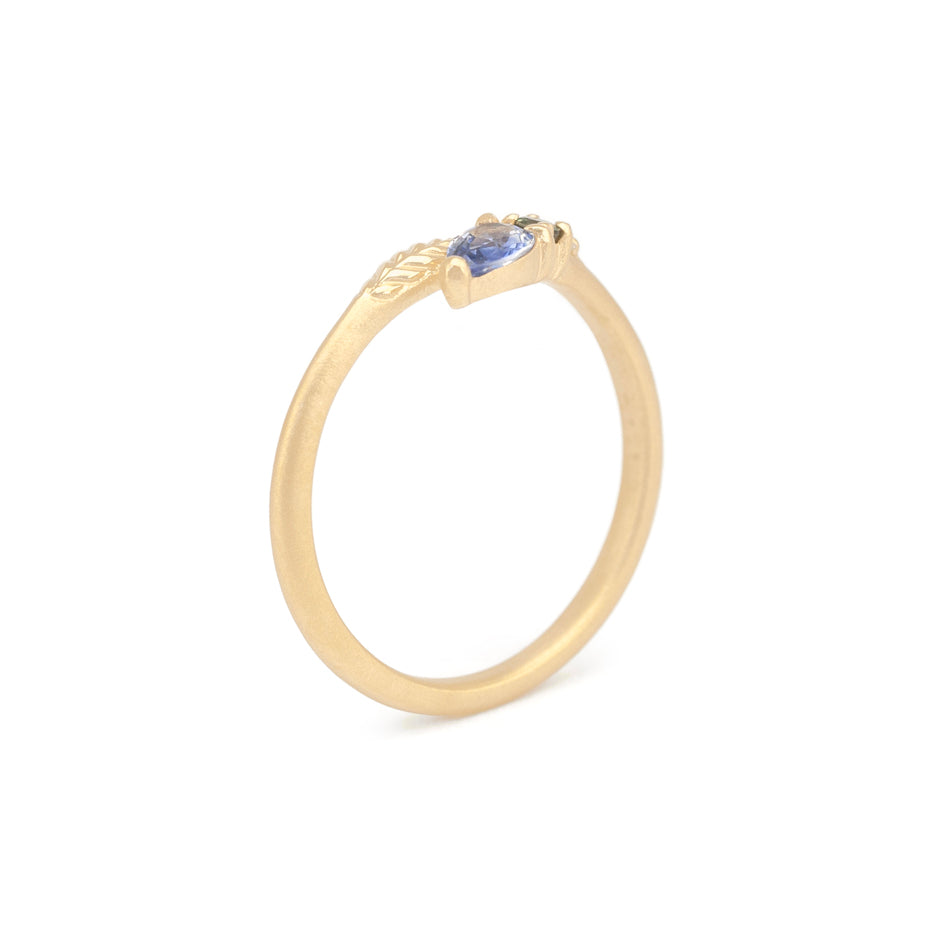 Blue Sapphire Ring in Yellow Gold with Botanical Detailing Through Finger View