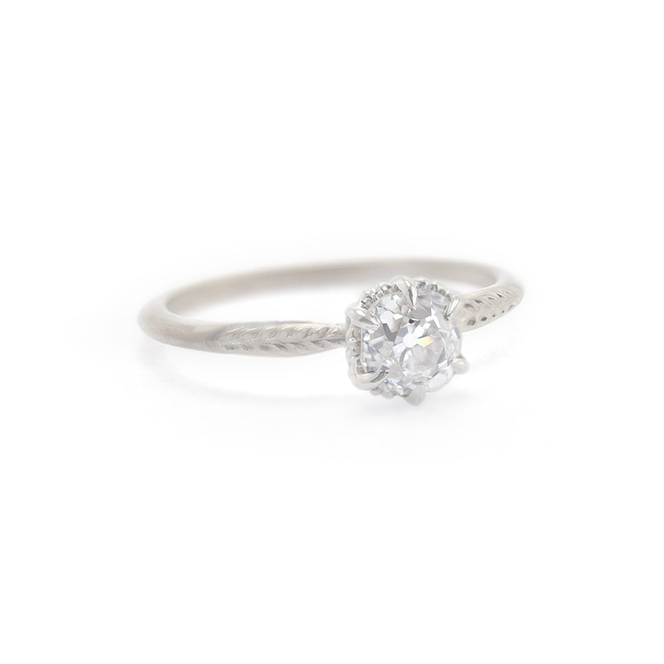 Handmade classic engagement ring featuring antique old mine cut diamond with botanical Evergreen details in 18K white gold by Designer Megan Thorne