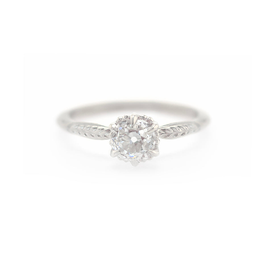 Handmade classic engagement ring featuring antique old mine cut diamond with botanical Evergreen details in 18K white gold by Designer Megan Thorne
