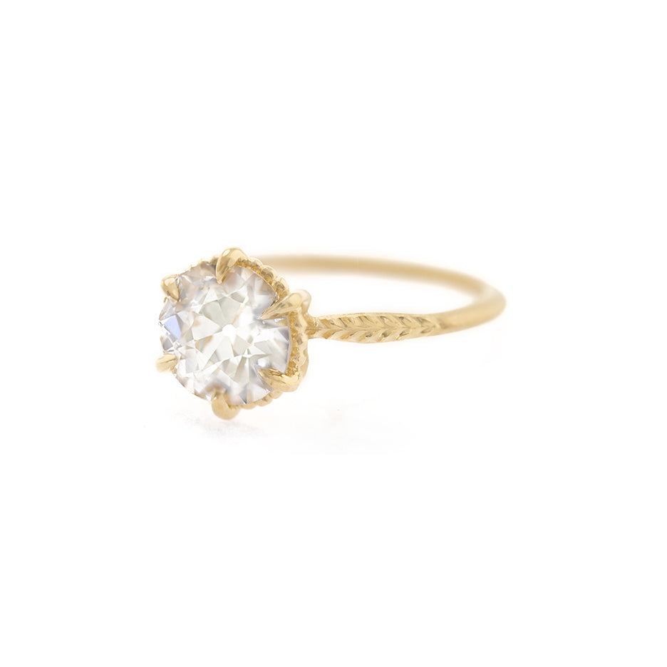 Handmade classic solitaire engagement ring featuring large warm fancy colored GIA 1.7ct light champagne Old European Cut Diamond and botanical Evergreen details in 18K yellow gold by Designer Megan Thorne