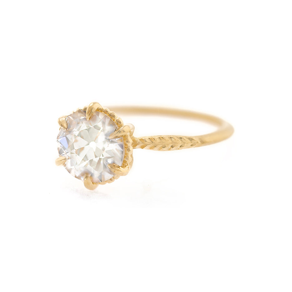 Handmade classic solitaire engagement ring featuring large warm fancy colored GIA 1.7ct light champagne Old European Cut Diamond and botanical Evergreen details in 18K yellow gold by Designer Megan Thorne