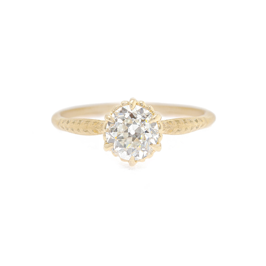 Handmade classic solitaire engagement ring featuring 1.01ct old European cut diamond and botanical details in 18K yellow gold by Designer Megan Thorne
