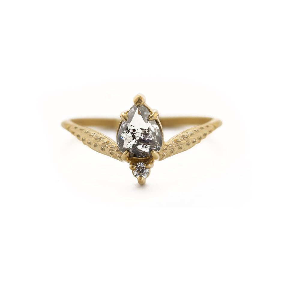 Handmade alternative engagement ring featuring salt and pepper diamond and antique diamond accent with botanical Evergreen details in 18K yellow gold by Designer Megan Thorne