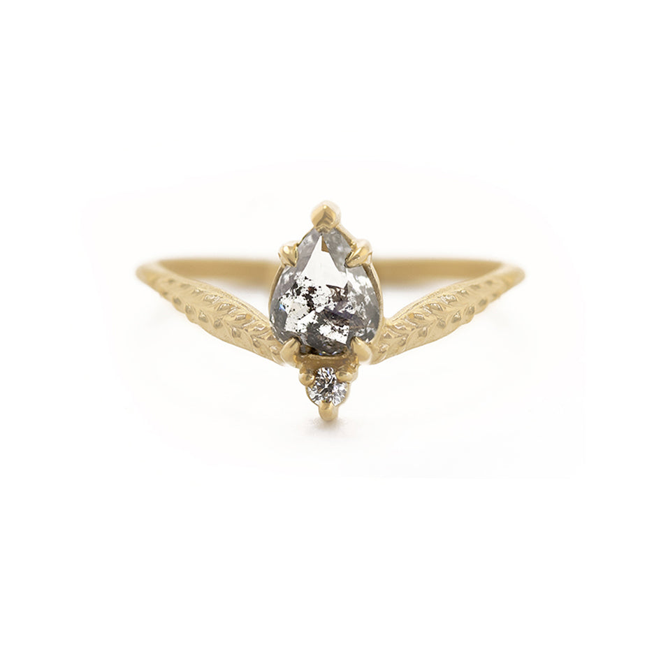 Handmade alternative engagement ring featuring salt and pepper diamond and antique diamond accent with botanical Evergreen details in 18K yellow gold by Designer Megan Thorne