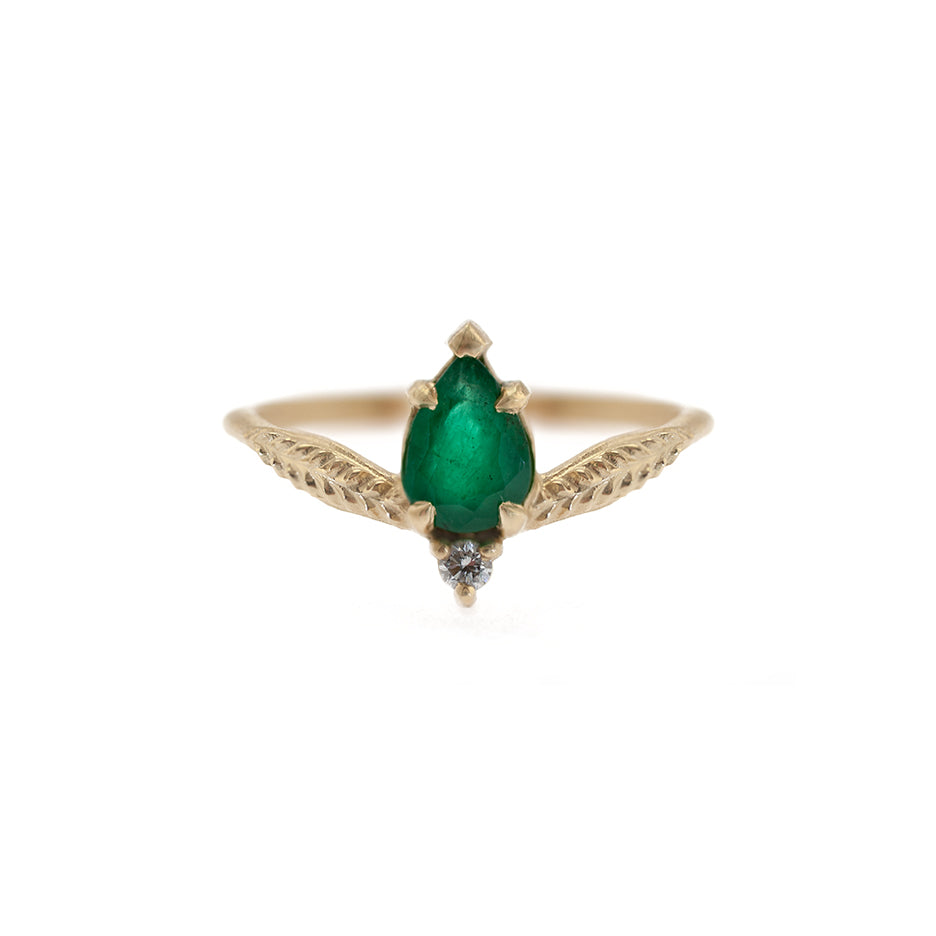 Handmade alternative low-set engagement ring featuring pear emerald and accent diamond in 18K yellow gold by Designer Megan Thorne