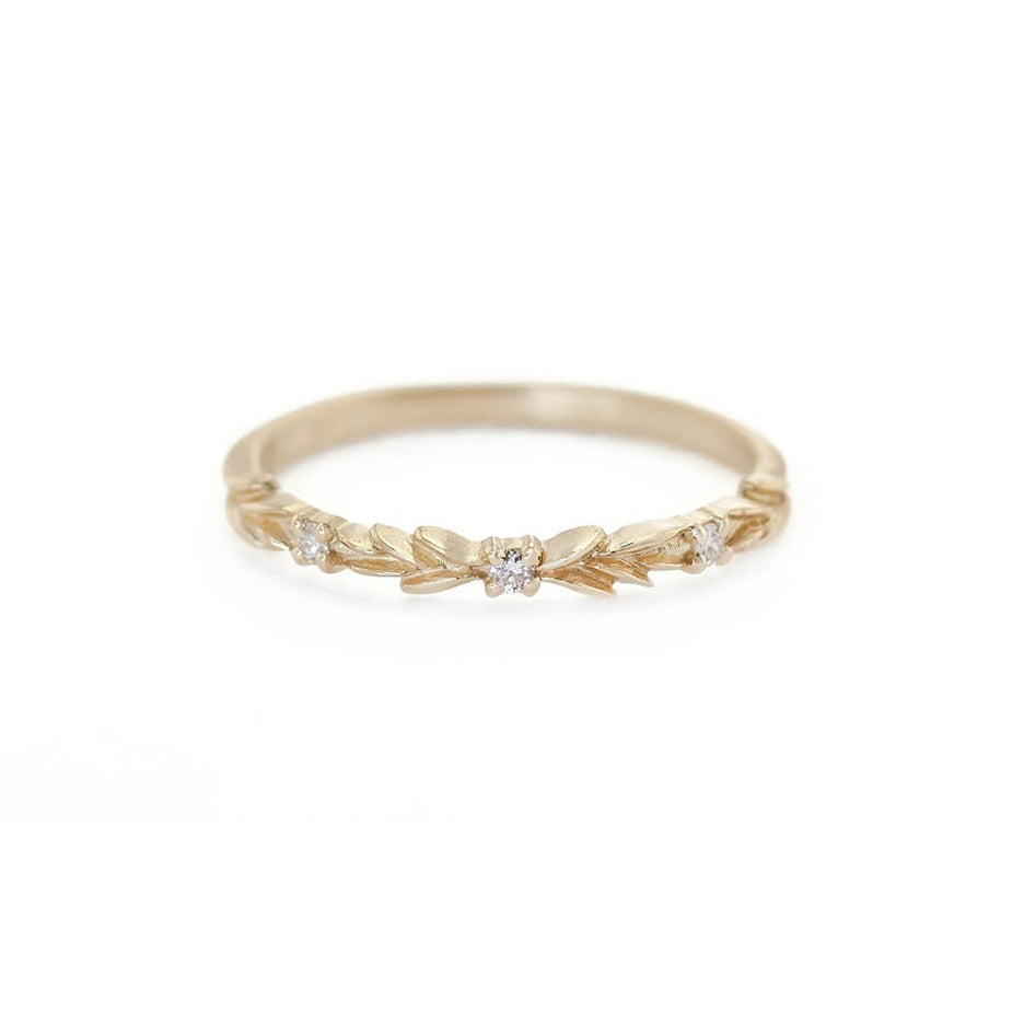Handmade wedding band with floral details in the top third and diamond accent stones by Designer Megan Thorne