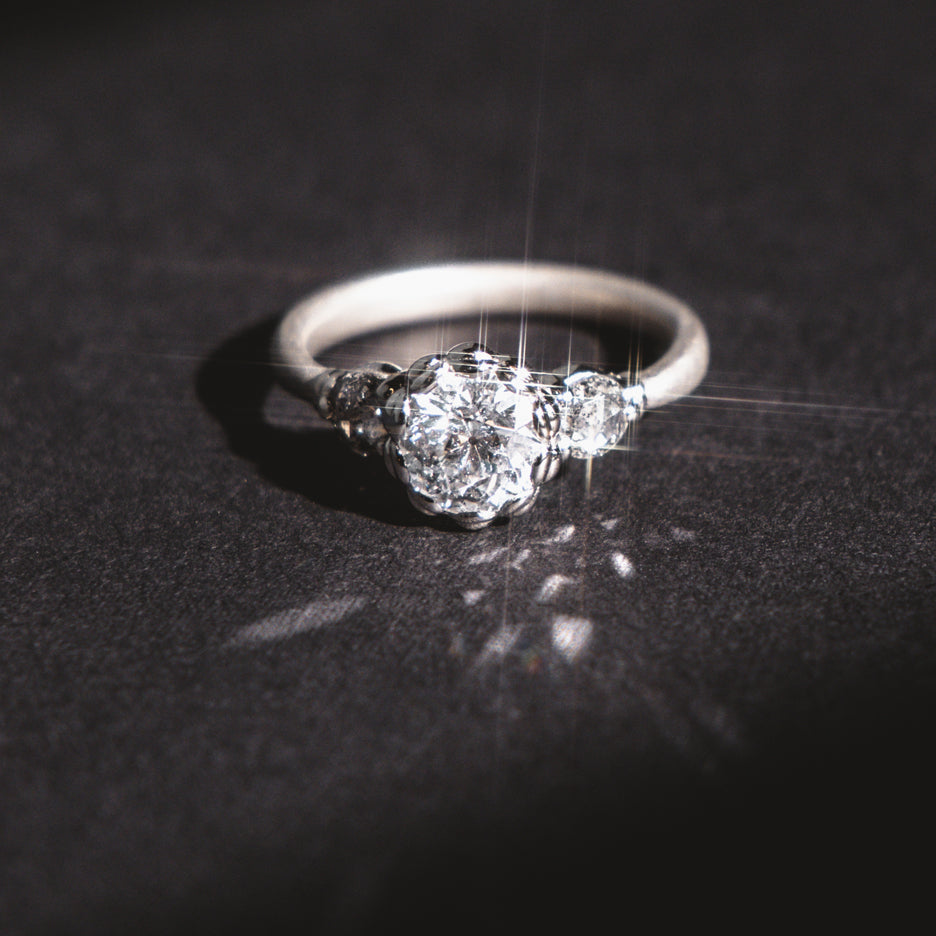 Antique Diamond Ring in White Gold with Detailing on Colored Background