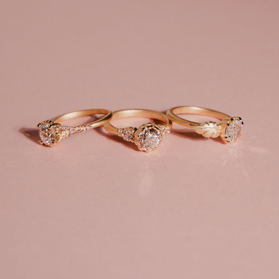 Diamond Non Traditional Engagement Ring in Yellow Gold with Detailing on Colored Background