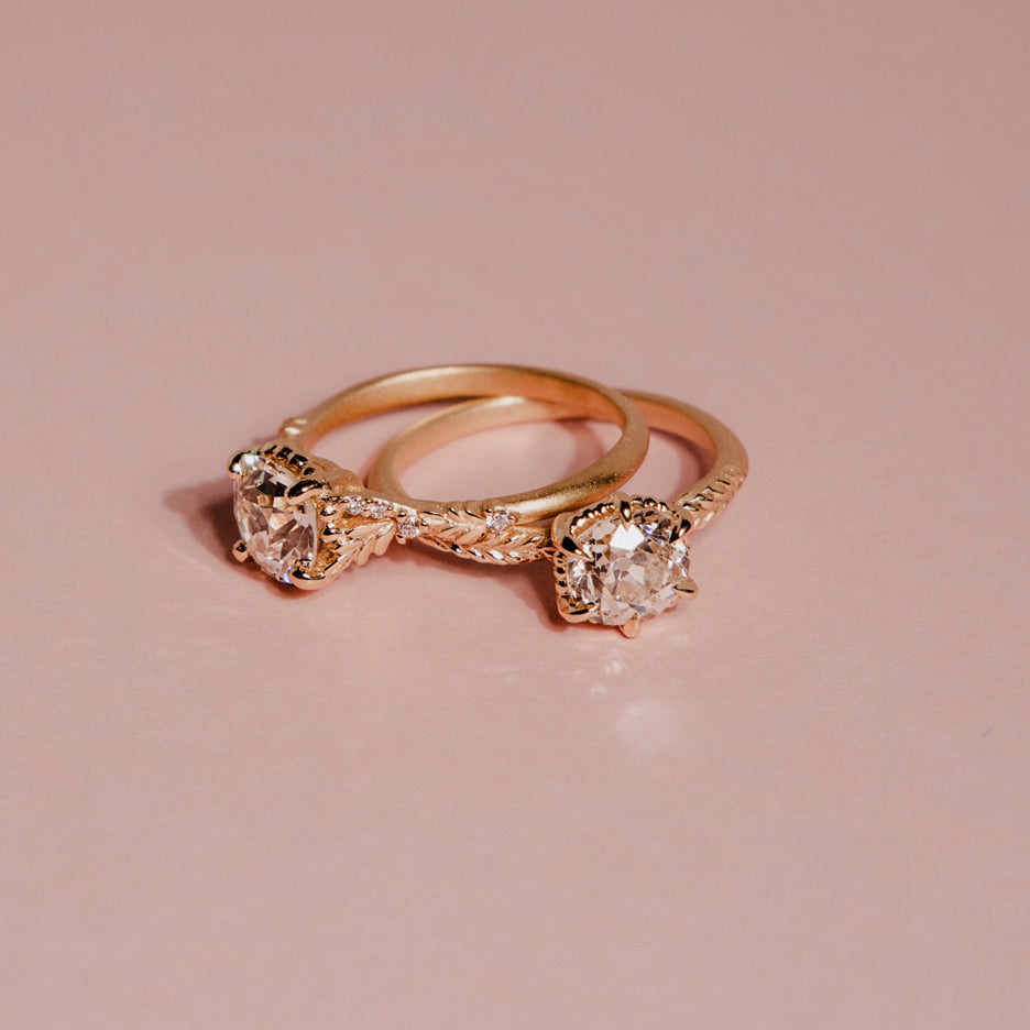 Antique Diamond Ring in Yellow Gold with Botanical Detailing on colored background