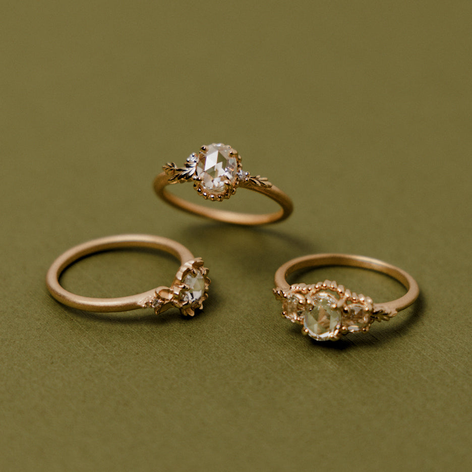 Rose Cut Diamond Engagement Ring in Yellow Gold with Botanical Detailing Through on Colored Background