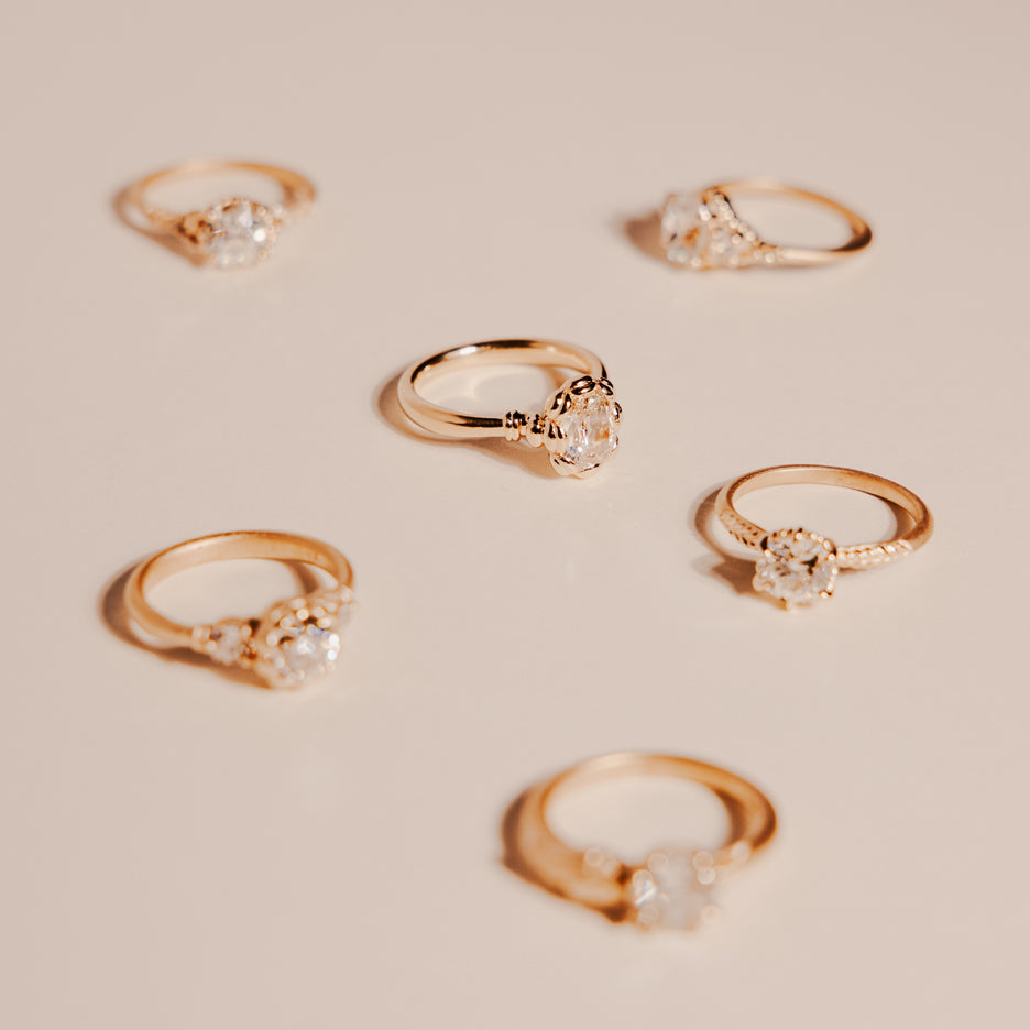 Diamond Engagement Ring in Yellow Gold with Detailing Front on Colored Background