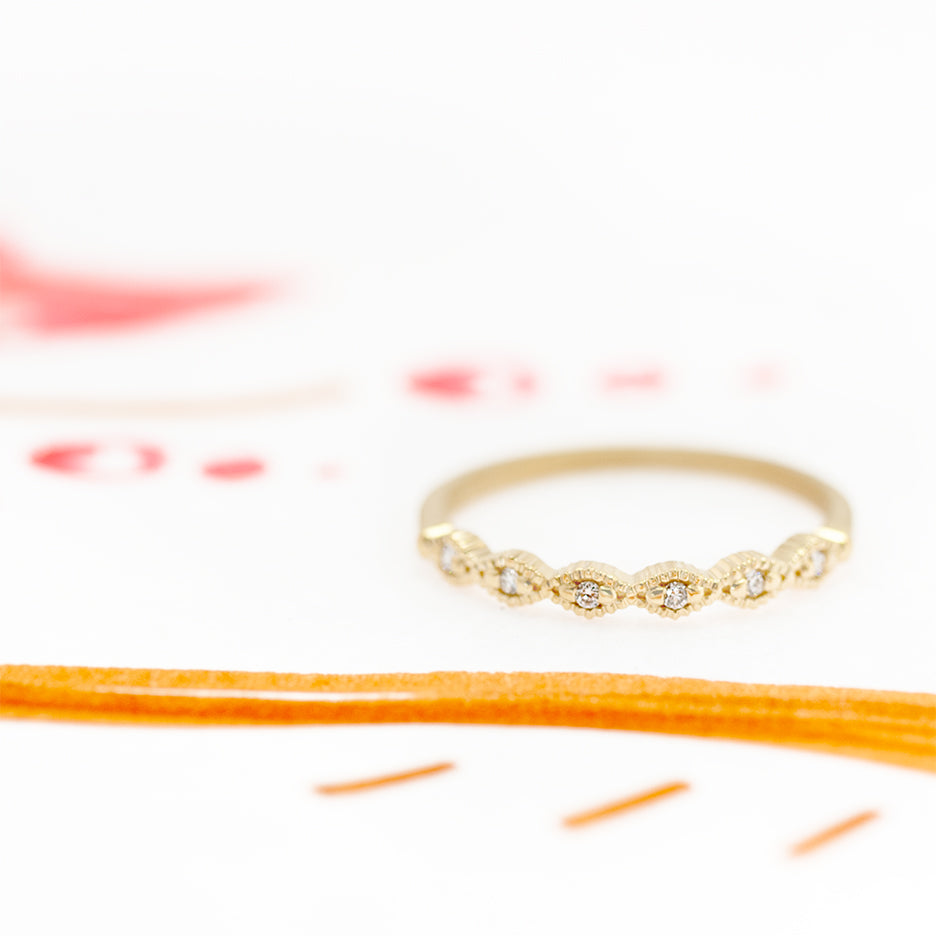 Handmade topper wedding band with classic ribbed triangle scallops halfway around and diamonds in 18K yellow gold. Vintage design by Designer Megan Thorne