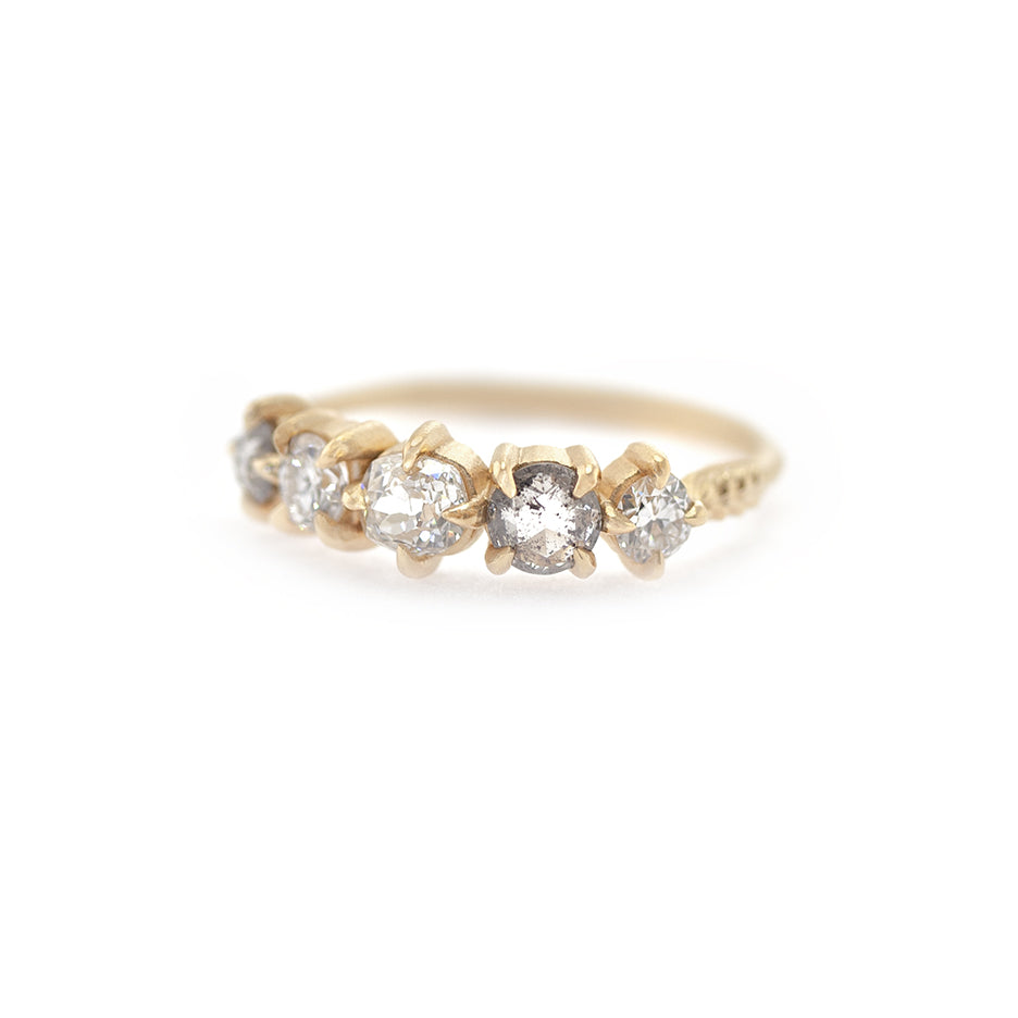 Handmade wedding band with a mix of antique white and salt and pepper diamonds in 18K yellow gold by Designer Megan Thorne