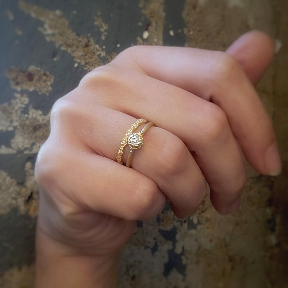 Handmade vintage inspired engagement ring featuring an antique diamond enrobed in 18K yellow gold scallops and ribbing. Classic design by Designer Megan Thorne on hand