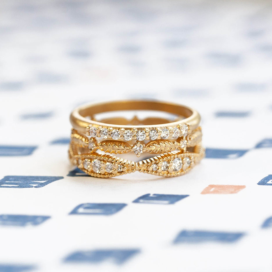 Handmade wedding band featuring botanical elements and white diamonds in 18K yellow gold by Designer Megan Thorne