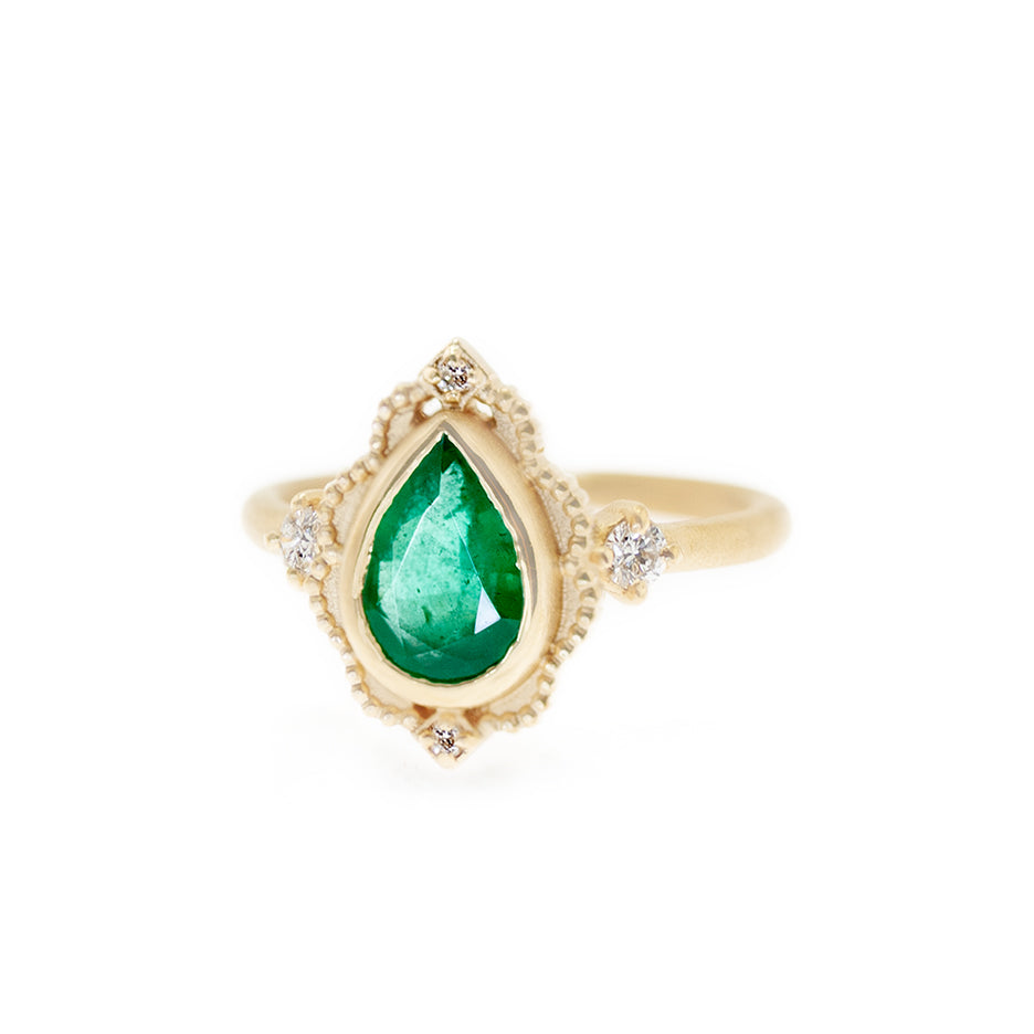 Handmade vintage inspired engagement ring featuring large pear emerald and diamonds with intricated details in 18K yellow gold by designer Megan Thorne