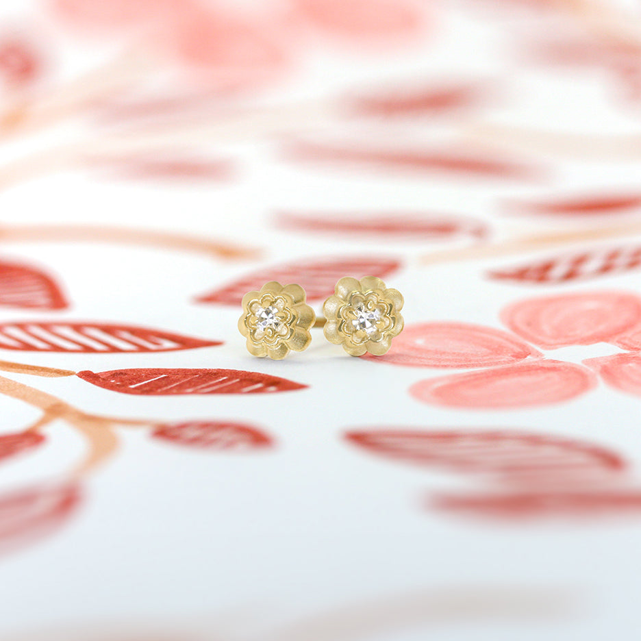 Handmade diamond studs with single cut diamonds set in a double scallop with prongs in 18K yellow gold by Designer Megan Thorne 