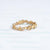 Handmade floral eternity wedding band with diamonds and flower and leaf details in 18K yellow gold by Designer Megan Thorne