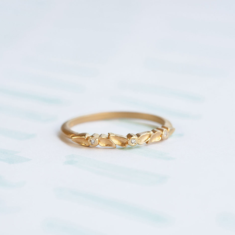 Handmade floral stacking ring or wedding band with diamonds and petal details in 18K yellow gold by Designer Megan Thorne