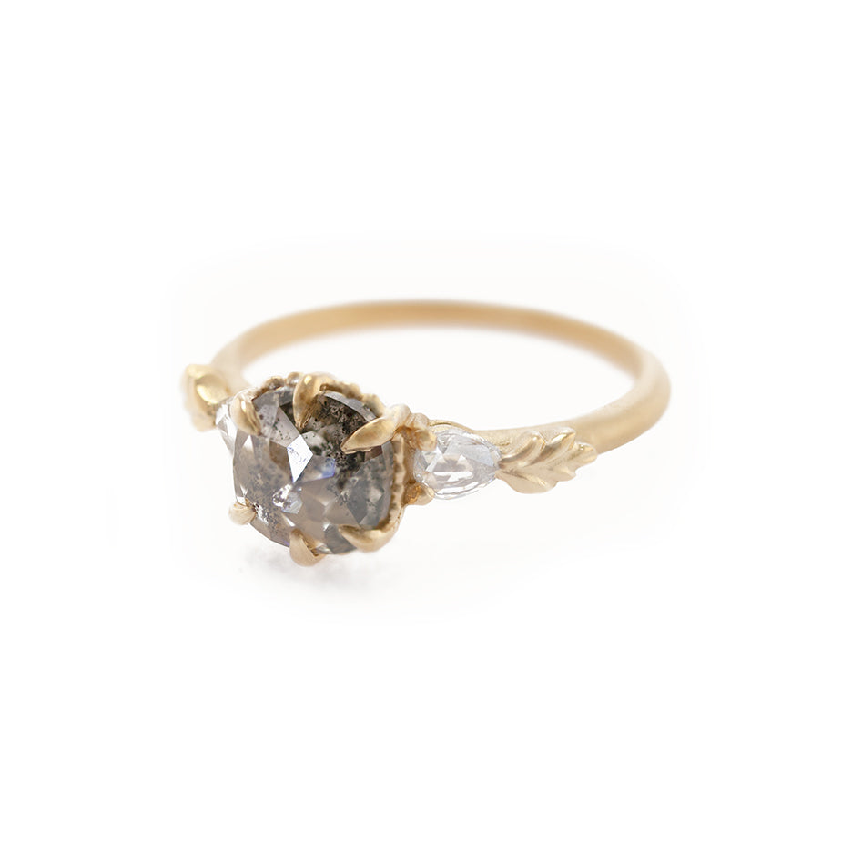 Handmade alternative 3-stone engagement ring featuring cushion cut salt and pepper diamond and rose cut pear sides with floral Wood Nymph details in 18K yellow gold by Designer Megan Thorne