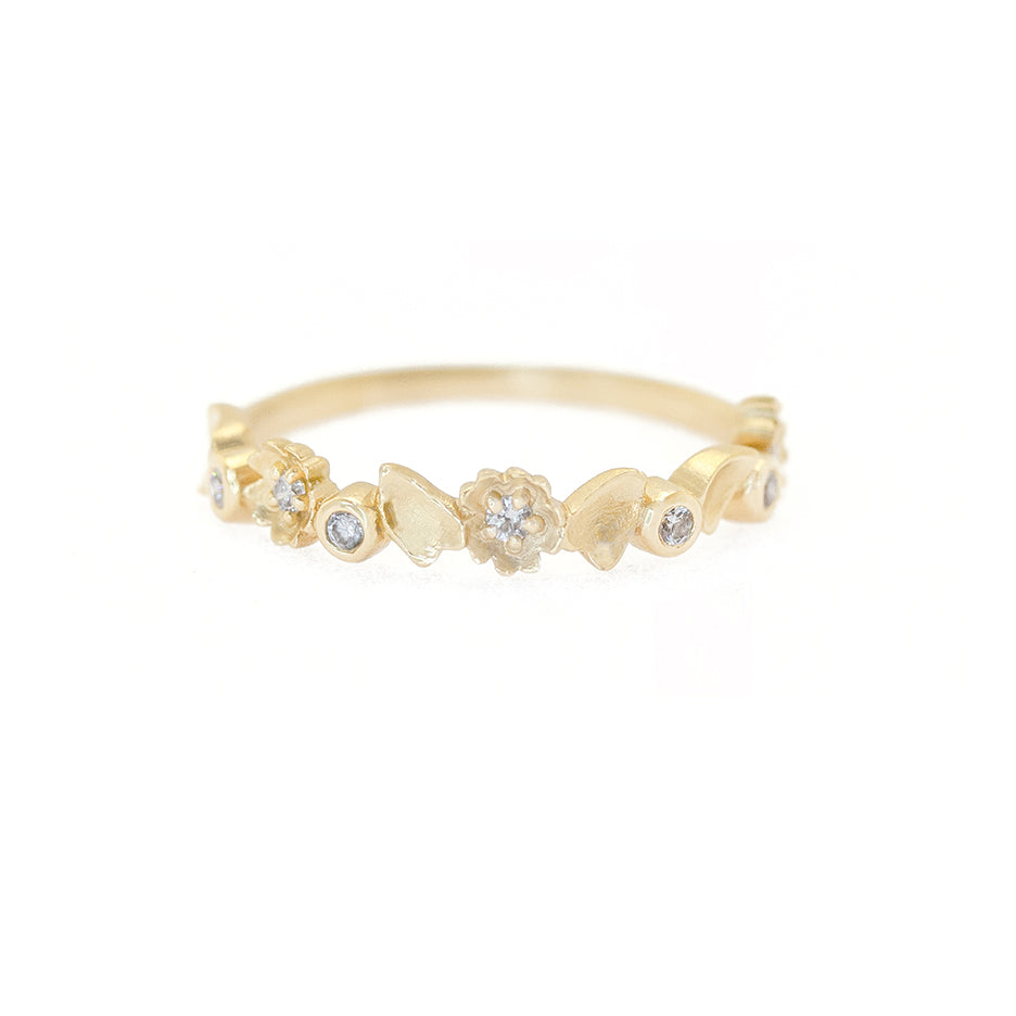 Handmade half eternity wedding band with buttercup floral details and diamonds set in 18K yellow gold by Designer Megan Thorne