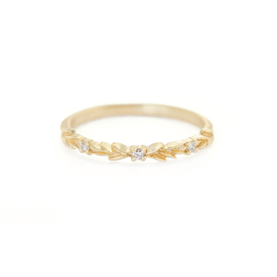 Handmade wedding band with floral details in the top third and diamond accent stones by Designer Megan Thorne