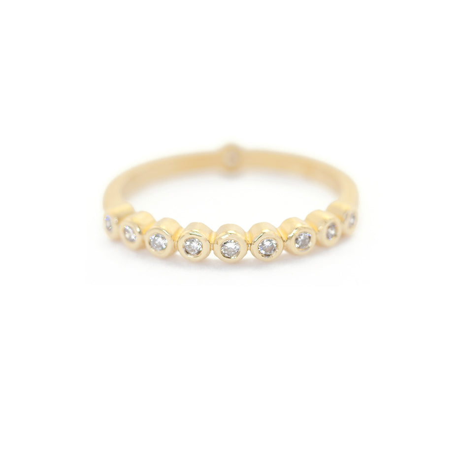 Handmade wedding or stacking band with bezel set diamonds in 18K yellow gold by Designer Megan Thorne