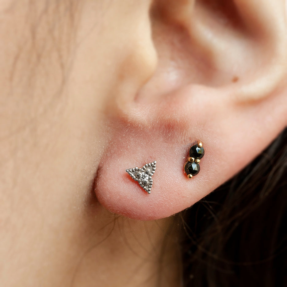 Handmade elongated triangle shaped stud earrings with ribbing, beading and diamonds in 18K white gold by Designer Megan Thorne