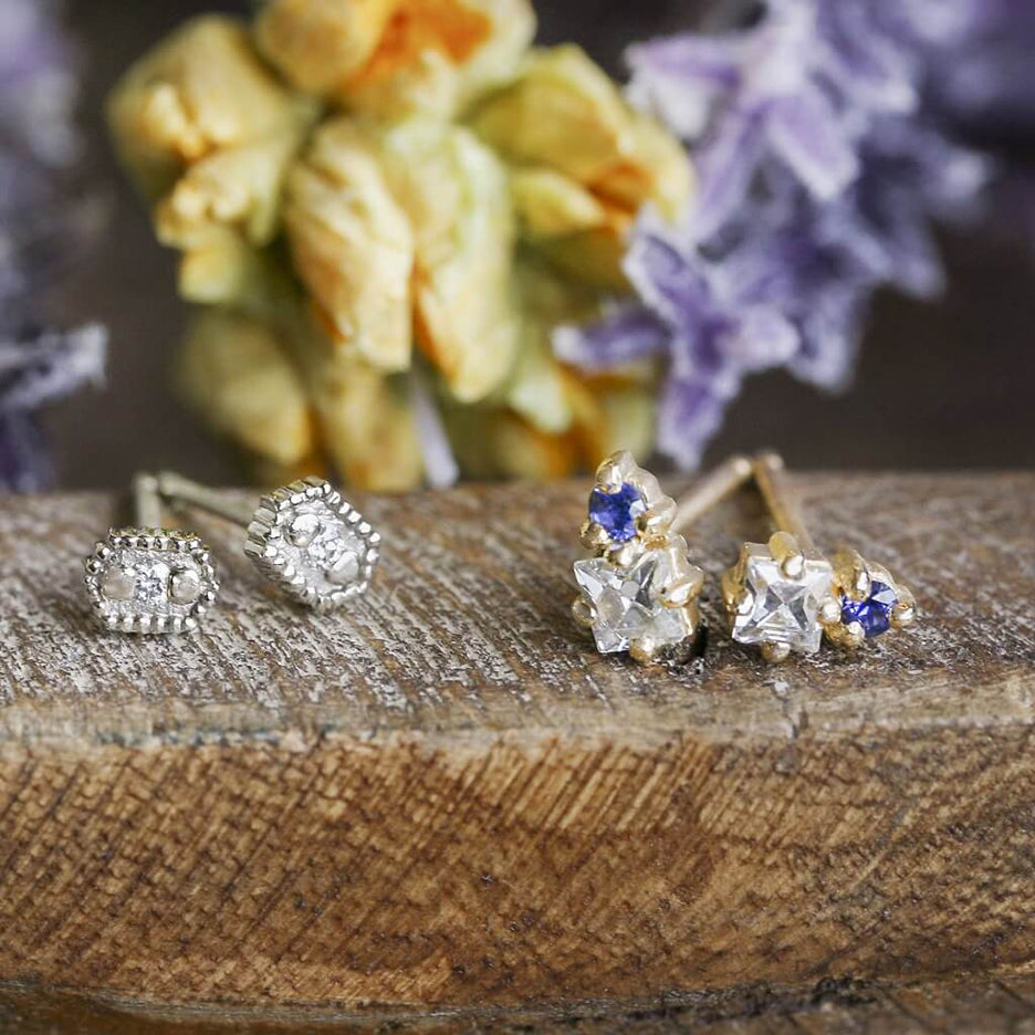 Handmade hexagon shaped stud earrings with ribbing, beading and diamonds in 18K white gold by Designer Megan Thorne