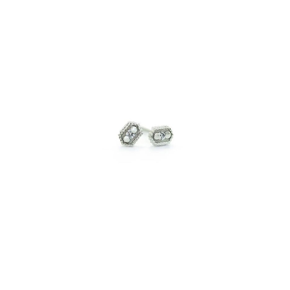 Handmade hexagon shaped stud earrings with ribbing, beading and diamonds in 18K white gold by Designer Megan Thorne