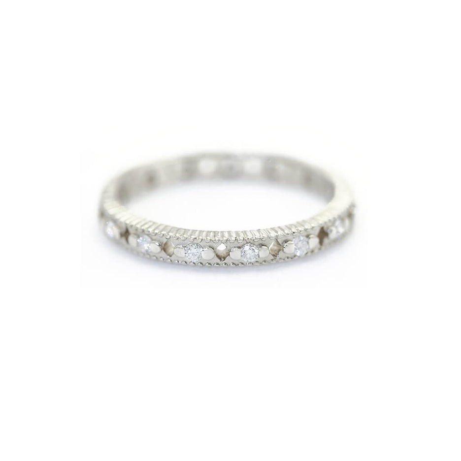 Handmade wedding band with ribbing and cut outs and diamonds in 18K white gold by Designer Megan Thorne 