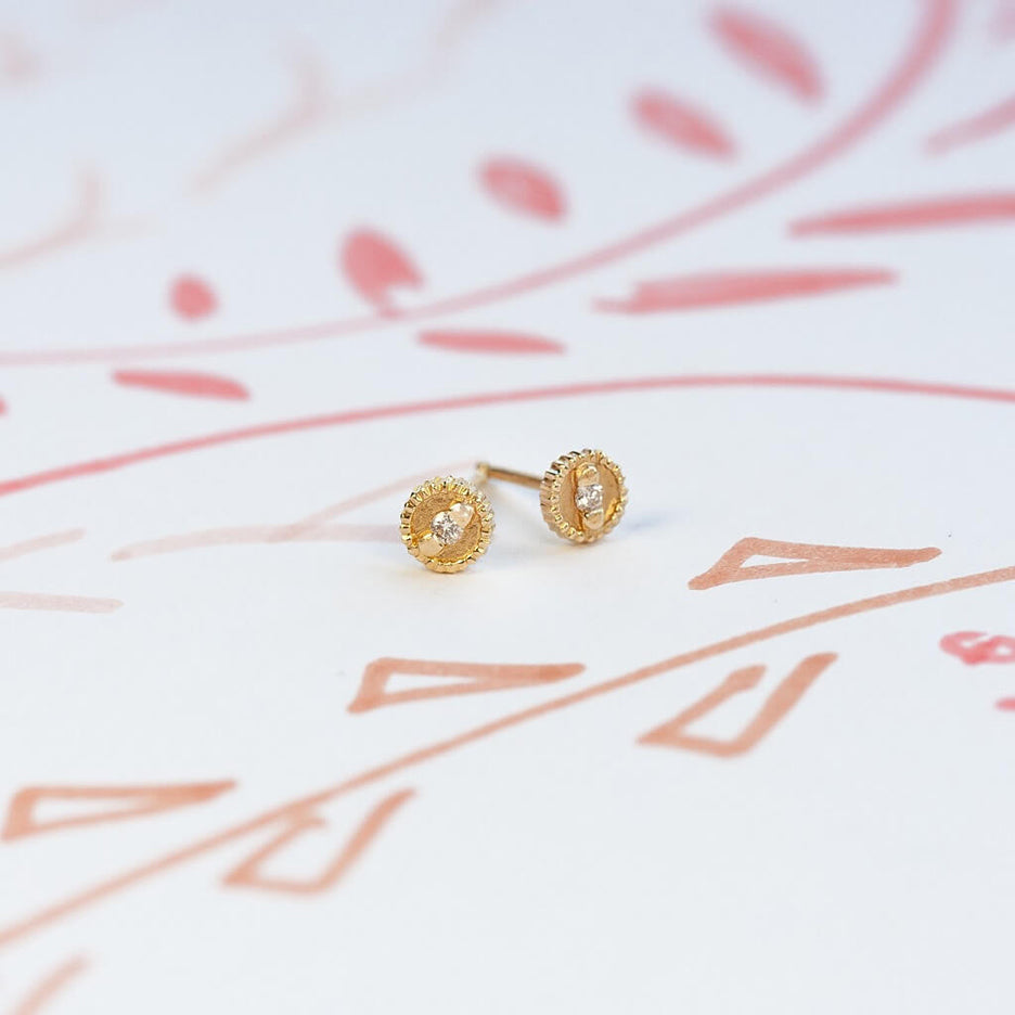 Handmade round stud earrings with ribbing, beading and diamonds in 18K yellow gold by Designer Megan Thorne