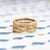 Handmade pave wedding or stacking band with diamonds and beading in 18K yellow gold by Designer Megan Thorne