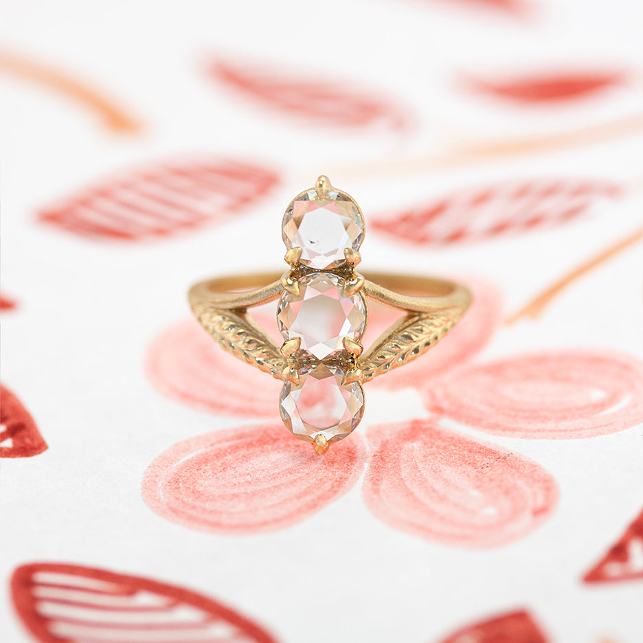 Antique Diamond Cluster Ring Navette Style in Yellow Gold on Colored Background